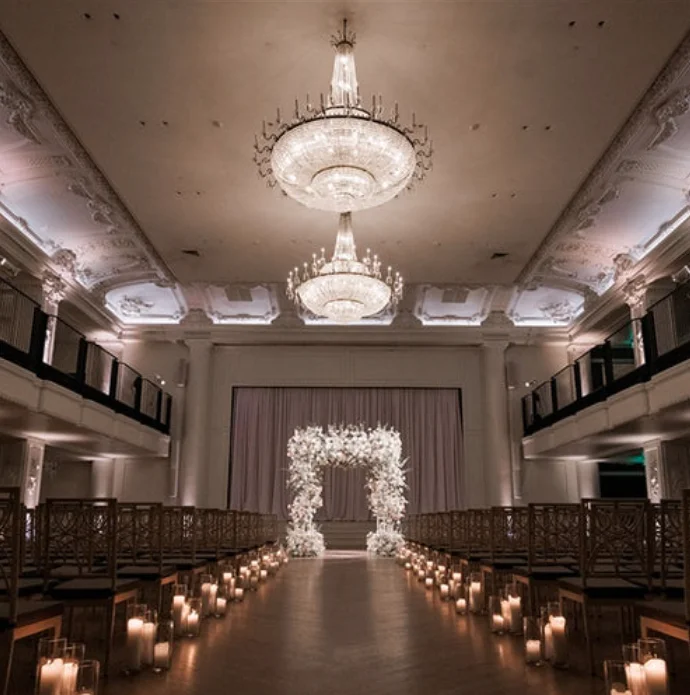 Wedding ceremony under crystal chandeliers at The Grand Belle at the Bellevue Hotel