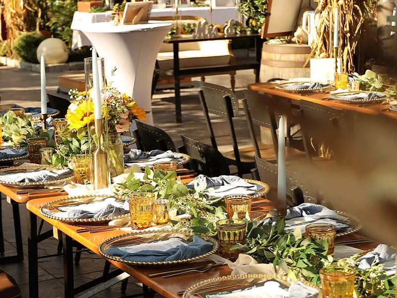 Rustic wedding reception tables with sunflowers and greenery at MudHen Brewery in Wildwood