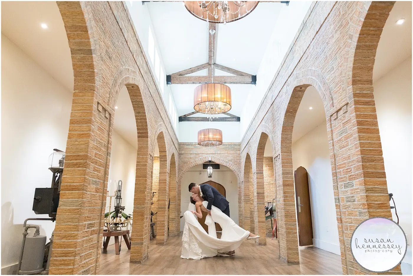 Couple dancing beneath brick arches at a Vineyard Ballroom wedding at Renault Winery
