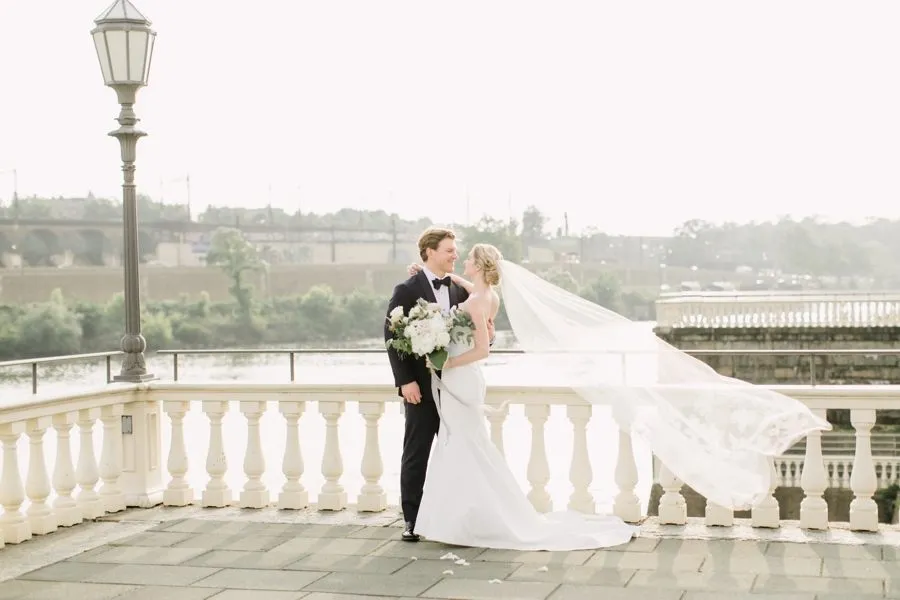 Bride and groom on the balustrade terrace above the Schuylkill River at Water Works by Cescaphe